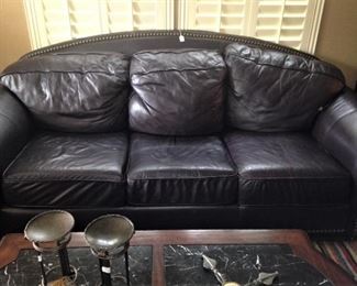 This leather sleeper sofa has a matching chair.