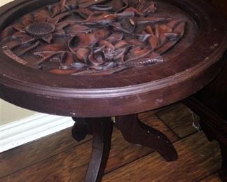 One of two carved wood tables