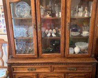 Dining room hutch, crystal drinking glasses, and milk glass