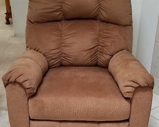 There are 2 matching light brown recliners