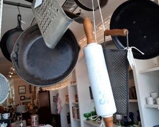 Variety of cast iron pans and glass rolling pin