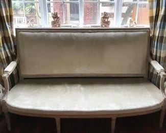 18th Century Louis XVI settee, approximately 66 1/4" wide, 41" high and 25 1/2" deep. The color is a beautiful gray wash with gilded touches and it is covered in a green/gray velvet. Price is $1400.00