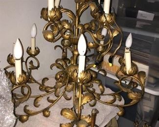 This is a gilt metal chandelier from the mid-20th century.  It is covered in leaves and has 12 lights, eight on the bottom and four on top.  It is approximately 25" high and 26" wide not including the piece it hangs from.  Price: $275.00