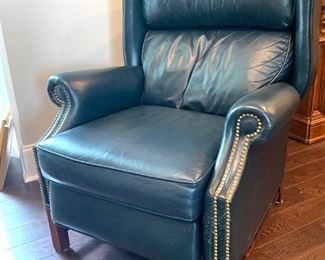 there are a pair a navy blue leather recliner chairs