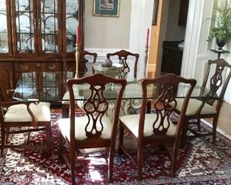 8 Chippendale chairs, a glass top table with a heavy plaster base (the rug and china cabinet in this photo are not for sale)