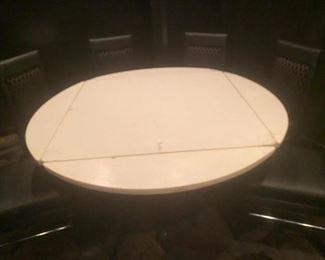 Drop leaf table
42x42 square and opens to 58" round
Padded linoleum top
Heavy duty metal base