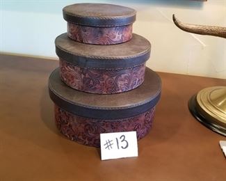 #13 ~($20)  Set of three stacking boxes with embossed leather sides and leather lids. Largest is 11" diameter