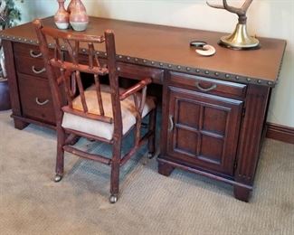 #14 ~($350)  Mahogany desk with leather top held down with brass studs on sides. See photo of slight Sun fading to leather. - Measures 68"W x 17"deep x 36"H.   