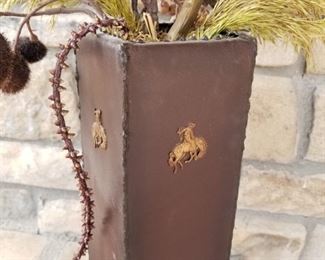 #145 ~($20)  Tall tin rectangle vase with cowboys.  Dried floral.  Vase is 16" tall not including floral. 