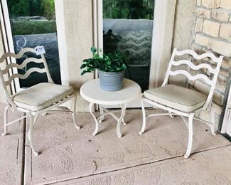 #130 ~ $200- Patio Set includes, 2 cream colored  wrought iron chairs w/ solid seat cushions, 1 matching round end table, 1 ceramic pot with faux plant- Great condition, heavy!