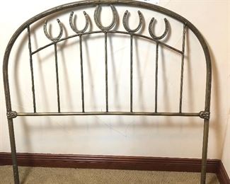 #203 ~ ($75) Metal twin headboard with a horse shoe theme.  No hardware included.  