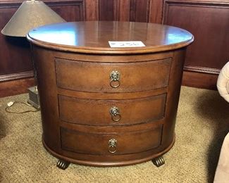 #256 ($150) Lexington (Palmer Home Collection) oval end table.  This wood (maple)? has been treated to appear as leather.  Very unique and beautiful! Great condition! Comes with protective glass top.  29.5"W x 21" x 23.5"H.  Three drawers
