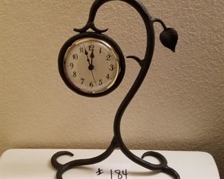 #184 ($40)~ iron black table clock, battery operated.   13.5" tall.