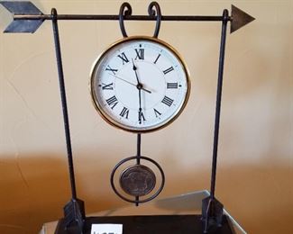 #251 ($60) Iron table clock measures 21"H x 18"W x 4.5"D. Battery operated, pendulum is a buffalo nickel, does not swing.  Chimes.