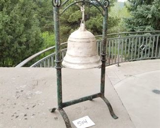 #504  ($30)  Wrought iron base holds us this heavy bell.  Deco.  20" tall x 9"w.  
