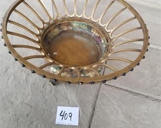 #409 ($20) gilded brass plant stand on legs.  Holds a 7.5" pot or smaller.  Measures 18" diameter x 7.5" tall.