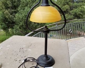 #417 ($80) beautiful HEAVY wrought iron table lamp with Amber colored glass shade.  Stands 24" tall.