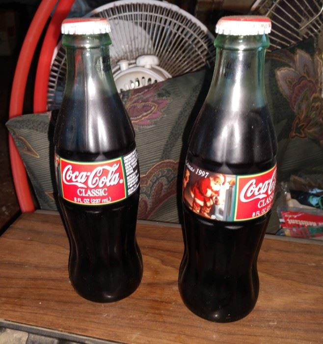 Small, 1990s Coca Cola bottles with Santa design. Still filled with Coke!
