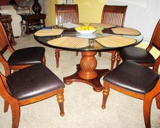 Cindy Crawford Key West Palms Collection. Glass topped Pedestal table with six black leather chairs. 1 year new. Was $1500 new.