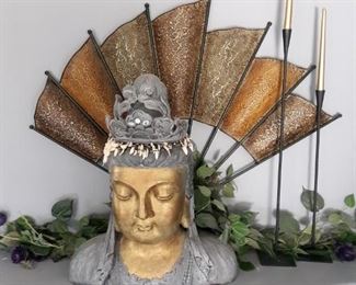 Large buddha head, hanging wall fan decor and two tall black candlestick holders