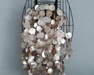 Oval wall hanging with dangling shells