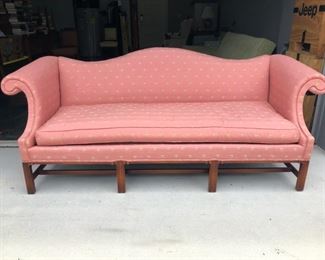 Pink fabric upholstered camelback sofa. Reproduction Chippendale. Removable cushion is zippered. 
