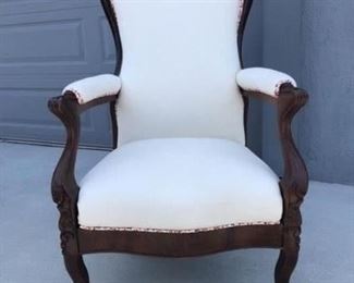 Hand carved wood sitting chair with white upholstery