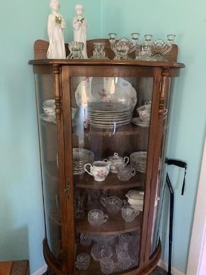 Curved Glass Curio loaded with China, Pressed Glassware, sugar/cremer, etc.  Antique Pressed Punch Bow/stand and cups...