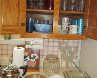 Cabinets loaded with glassware, cups, pyrex, etc.