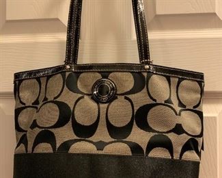 Black and grey tote one outside pocket. Open inside with inside side pockets $50.00
