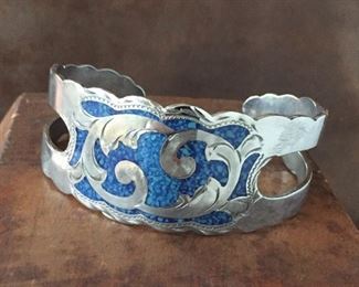Silver cuff bracelet with turquoise chip inlay. 5 3/4" inner circumference with 1 1/4" gap, flexible. Stamped ALPACA MEXICO on back. $74
