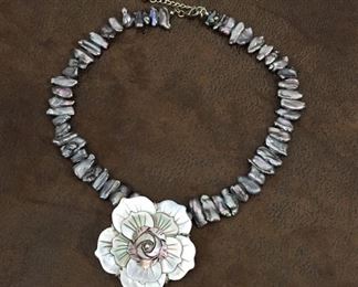 BEAUTIFUL satiny gray peacock biwa pearl necklace with 3D carved mother of pearl flower pendant. Length flexible from 16" to 18".  $130
