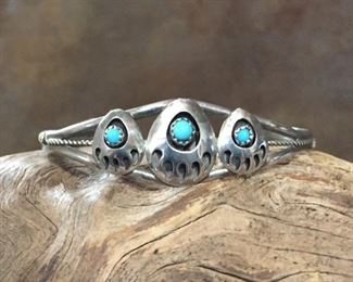 Vintage Native American silver cuff featuring 3 silver bear claws, each with a turquoise cabochon.  5" inner circumference with 1 1/4" gap.   $160
