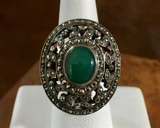 Size 6 3/4  sterling silver ring studded with marcasite and featuring a gorgeous green gemstone. Signed L & stamped c 925. $100
