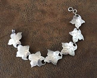 Lovely vintage sterling silver bracelet featuring seven leaf-shaped links, each with amazing hand-incised vein detailing. Length is 8 1/4". Stamped STERLING on back side of each of the two end leaves. $88
