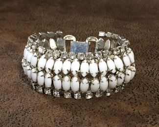 Vintage bracelet outlined in clear prong-set rhinestones and featuring marquise-shaped prong-set milk glass cabochons down the center. 7 1/4" x 1 1/8". Unsigned, and goes well with the Hobe milk glass. $88
