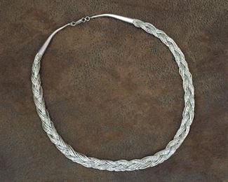 Vintage 18-strand braided liquid silver necklace. 19" length.  Stamped sterling on the end cones.  This will be your "go with everything" classic.  $120
