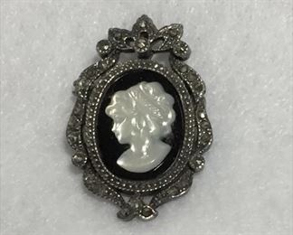 Lovely vintage sterling silver, onyx, marcasite and mother of pearl cameo brooch/pendant with hidden bale. 7/8" x 1 3/8", stamped 925 and signed SU.  $70
