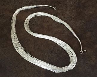 Gorgeous 30-strand liquid silver necklace. Extra long 30".  Finished with silver cones stamped STERLING. $164

