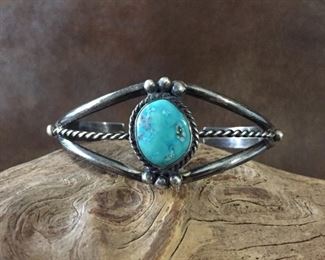 Vintage Native American silver cuff with gorgeous turquoise cabochon.   5" inner circumference with 1" gap. Size could be adjusted some.  Signed 3H.   $125
