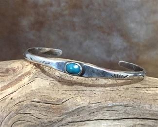 Old pawn Native American stamped silver and turquoise cuff.  Turquoise is a little washed out in photo - it's a gorgeous dark teal, almost green color.   5 1/2" inner circumference with 1 1/2" gap.  $115
