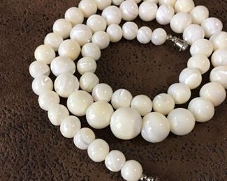 21" vintage necklace with polished mother of pearl beads graduating in size from 13mm in the center to 7mm near the clasp.  $70