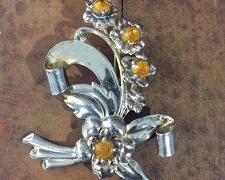 Sterling silver floral brooch with gold rhinestone-centered flowers. Marked STERLING on the back.   2 5/8" x 2 1/8".  $70
