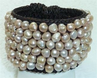 Genuine freshwater pearls in pale pastels of peach, pink, cocoa and creme sewn on an extra wide woven chocolate macrame cuff bracelet.  Yummy!  $120