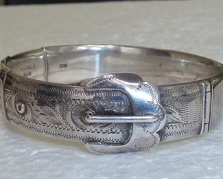 W.T. Toghill & Company made this fabulous sterling silver bracelet in Birmingham England in 1960.  That is the story told by the British Hallmarks inside this beautiful hinged bangle bracelet.  It is in excellent condition.  $140