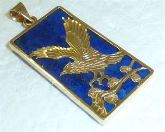 14k gold and lapis lazuli pendant.  1 3/8" by 1/2".  It is marked 14k, and has a maker's mark that I cannot make out.  Beautiful Lapis, and nicely detailed Eagle.   $240