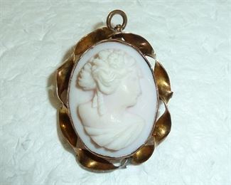 Lovely pale pink and white cameo with a 10k yellow gold bezel.  Measures 1 1/8" by 7/8".  $140
