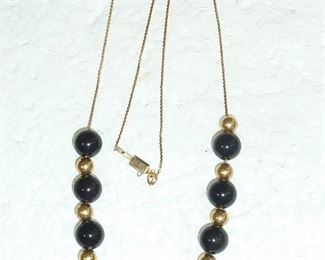 14k gold and black onyx add-a-bead necklace.  16" long.  $220