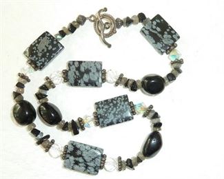 Artisan-made 17" necklace with snowflake obsidian, onyx, labradorite, Swarovski crystal and sterling silver beads.  Sterling silver toggle clasp.  $72