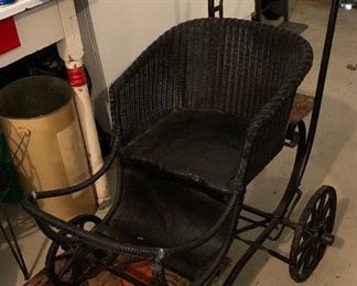 Antique wicker and leather stroller. 